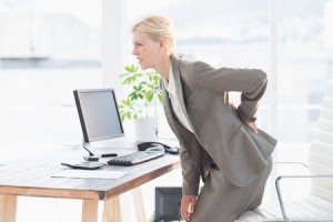 42576909 - sad businesswoman having back pain in her office