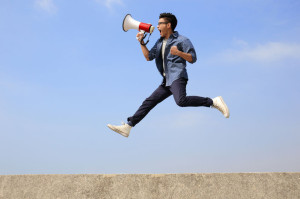 36620542 - man jump and shout by megaphone with blue sky background, asian