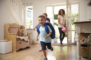 71214448 - excited children returning home from school with mother