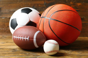 50048676 - sports balls on wooden background