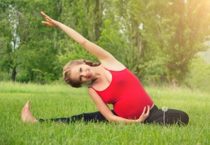 15037561 - healthy pregnant woman doing yoga in nature outdoors