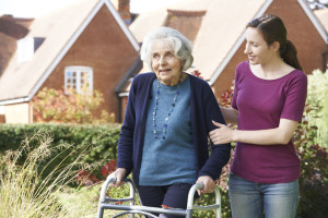 46779387 - daughter helping senior mother to use walking frame